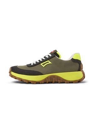 Green and black sneakers with a rubber sole, white laces, and yellow accents. Features textured fabric and a cushioned heel.
