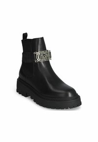 Black leather ankle boot with a textured rubber sole, side elastic panels, and a decorative silver band across the ankle.