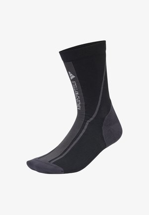 Calzino sportivo nero con design a coste, tallone e punta rinforzati, dettagli grigi e logo sul lato.
