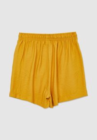 Shorts jaunes à taille élastique en tissu léger, présentés à plat sur un fond clair uni.