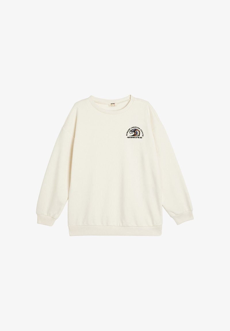 Sudadera color crema hecha de tela suave, con un cuello redondo y hombros caídos. Incluye un gráfico bordado en el pecho.