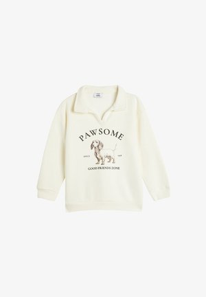 Cremefarvet sweatshirt med krave, der har en grafik af en dachshund og teksten "PAWSOME SINCE 1978 GOOD FRIENDS ZONE" nedenfor.