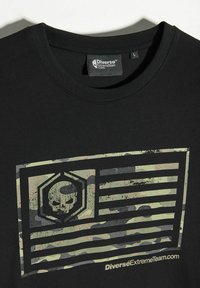 Czarny bawełniany t-shirt z przodem ozdobionym graficznym wzorem czaszki w kamuflażu oraz wzorem flagi, z tekstem logo poniżej.