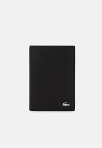 Schwarze Ledergeldbörse mit einem minimalistischen Design, ausgestattet mit einem silbernen Logo in der unteren Ecke und glatter Textur. Kompakte rechteckige Form.
