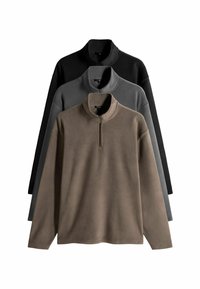 Rude kailiniai rudenio, pilkos ir juodos spalvos. Kiekvienas turi pusiau užtrauktuką ir ilgomis rankovėmis su minkšta, tekstūruota paviršiumi.