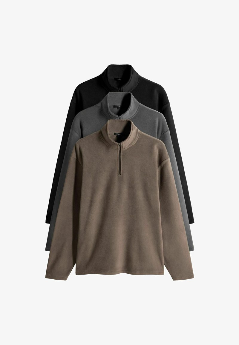 Rude kailiniai rudenio, pilkos ir juodos spalvos. Kiekvienas turi pusiau užtrauktuką ir ilgomis rankovėmis su minkšta, tekstūruota paviršiumi.