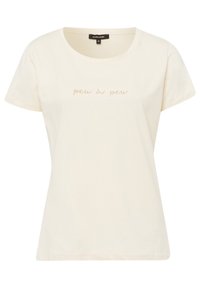 Camiseta de algodón color crema con cuello redondo y mangas cortas. Presenta el texto "peu à peu" en un diseño sutil y brillante.