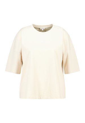 T-shirt en coton beige à manches courtes avec un col rond et une coupe décontractée, ample.