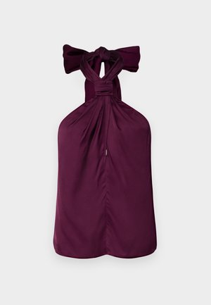 Top halter viola con un fiocco annodato al collo, caratterizzato da tessuto arricciato e orlo dritto. Texture liscia con un design strutturato.