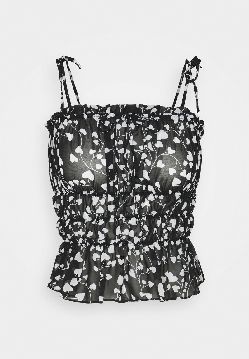 Haut court à imprimé floral noir et blanc avec bretelles réglables, texture froncée et ourlet à volants. Confectionné dans un tissu léger et transparent.