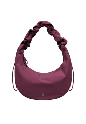 Borsa a mano viola a forma di mezzaluna con manico arricciato e dettagli con coulisse, caratterizzata da un piccolo logo "GOT BAG" nella parte inferiore anteriore.