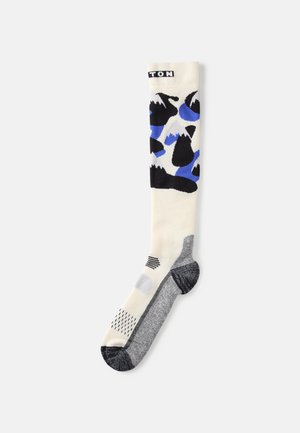 Meia até o joelho com uma base creme, apresentando padrões abstratos em preto e azul, com calcanhar e bico texturizados e detalhes listrados.