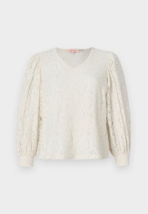 Čipkasta bluza v kremni barvi, z V-izrezom in dolgimi nabranimi rokavi. Ima teksturiran cvetlični vzorec in elastične manšete.
