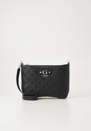 Black Guess wristlet bag with embossed logo pattern, silver-tone hardware, and zip closure on a plain white background.