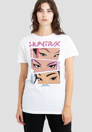 White cotton T-shirt with a graphic print of three stylized eyes. The design features bold colors, including pink and purple, with text accents.
