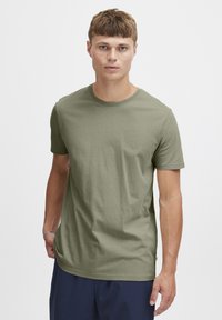 Olive green cotton t-shirt with a crew neckline and short sleeves; lightweight, smooth texture; no patterns or visible hardware details.