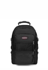 Zaino nero in nylon con numerosi scomparti con zip, tasca frontale in rete, spallacci regolabili e maniglia superiore per un facile trasporto.