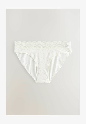 Culottes vert clair avec dentelle, en tissu blanc doux avec de petits pois orange. Style classique avec des bords sans coutures.