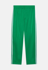 Πράσινα αθλητικά παντελόνια με ελαστική μέση, με άσπρες ρίγες στο πλάι, φτιαγμένα από λείο, ελαφρύ ύφασμα.