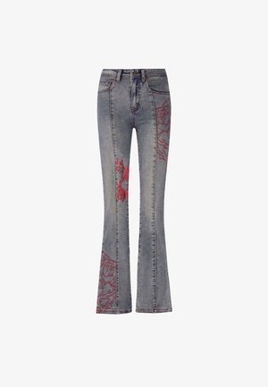 Flared jeans in faded blue denim with red embroidered floral and abstract patterns on outer legs. Standard five-pocket design and belt loops.