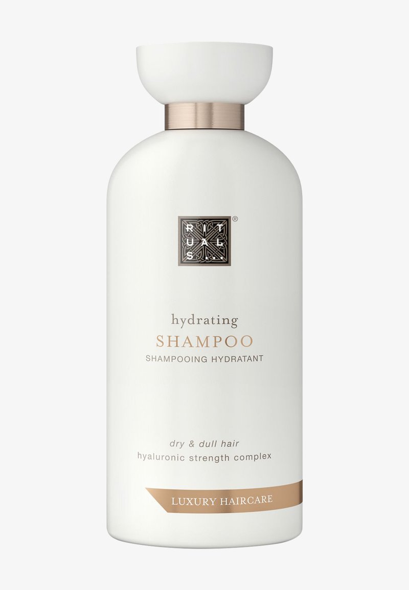 Kosteuttava shampoo matta-valkoisessa pullossa, jossa on pyöristetty muoto, hopeiset yksityiskohdat ja kultaiset tekstit. Sopii kuivalle ja elottomalle hiukselle.