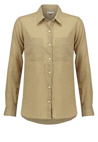 Chemise beige à manches longues avec deux poches poitrine avant, col classique et poignets boutonnés.