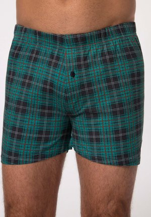 Boxershorts in een groen en zwart geruit patroon, met witte en rode accenten, van zachte stof en met een enkele knoopsluiting aan de voorkant.