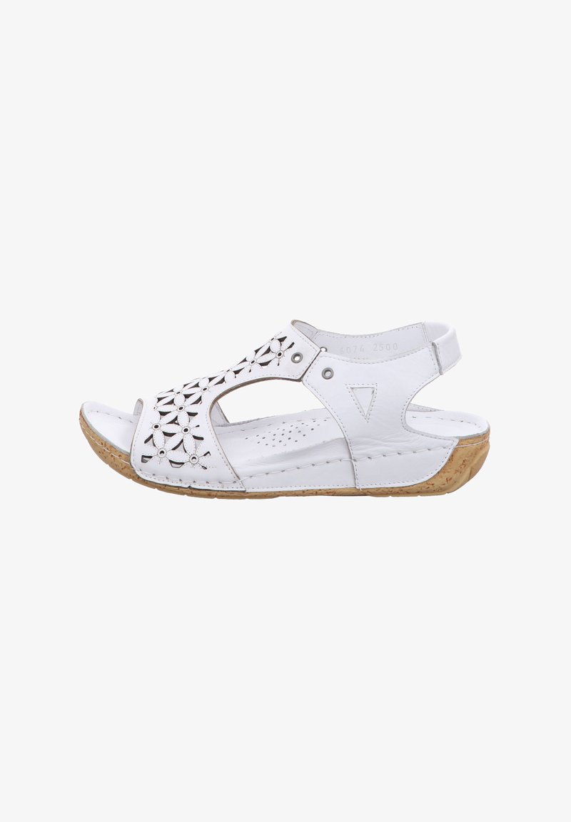 White leather sandals with cut-out floral design, open toe, adjustable back strap, and a textured beige cork sole.