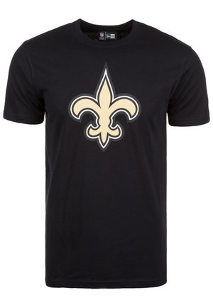 Camiseta de algodón negra con un gran logo de color crema de flor de lis en el frente. Diseño de mangas cortas y cuello redondo.