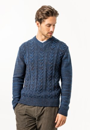 Dark blue knitted sweater featuring a cable pattern, v-neck, and ribbed hem and cuffs. Made from textured material with subtle color variations.