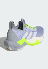 Gray athletic shoe with a textured upper, neon green accents, and three white stripes. Features a molded heel and cushioned sole design.