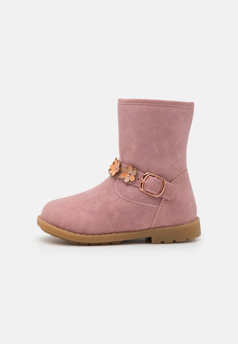 Pink faux leather ankle boot with a rounded toe, decorative flower accents, and a side buckle. Features a sturdy rubber sole.