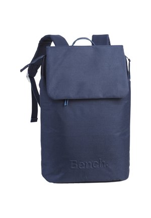 Navy blue fabric backpack with a flap closure, adjustable straps, top handle, and embossed "Bench" logo on the front.