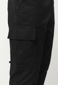 MELA RAJESH - Cargobroek - schwarz