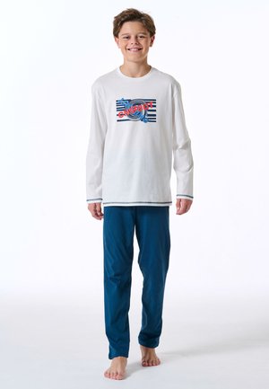 White long-sleeve shirt with a colorful "chill out" graphic, paired with blue pajama pants. Both items made from soft fabric.