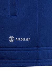 Blå sportskjorta gjord av ett andningsbart material, med en mjuk textur, sydda sömmar och en vit "AEROREADY"-logotyp med en globikon.