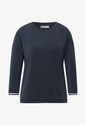 Chemise bleu marine à manches longues avec encolure ronde, épaules tombantes et poignets à rayures blanches.