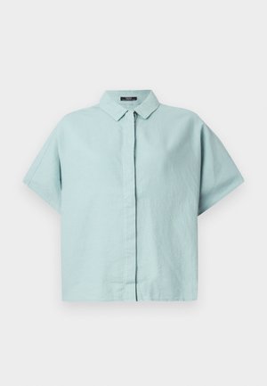 Light blue short-sleeve collared shirt made from textured fabric; features a button-down front and relaxed fit. Simple design with no patterns.