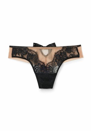 Black lace thong with sheer nude panels, floral patterns, and a bow accent. Features a low-rise design and minimal coverage at the back.