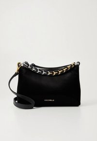 Mustast nahast käekott, millel on sile tekstuur, kaunistatud punutud kuldse ja hõbedase kett-õlapaelaga ning ülalt tõmblukuga sulgemine. Ees on logo.