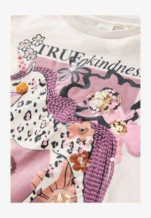 Felpa chiara con un design di unicorno decorato con paillettes e ricami, arricchita da fiori e dal testo "VERA gentilezza."