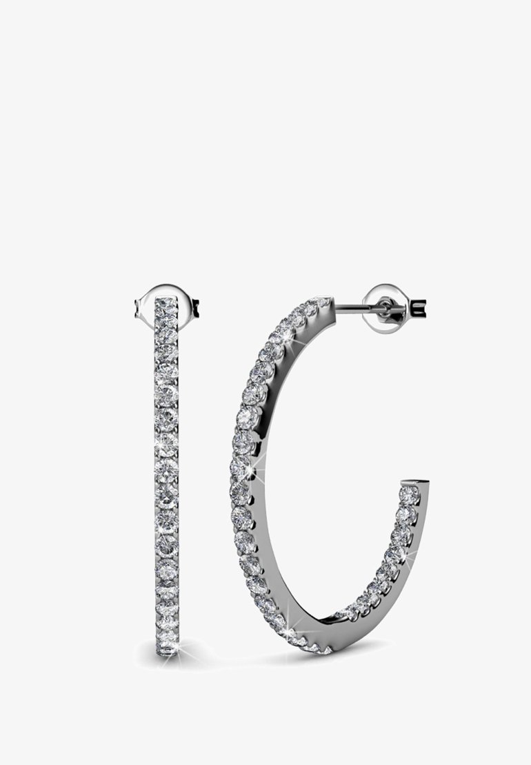 Orecchini a cerchio in metallo di tonalità silver, con una fila di falsi diamanti rotondi e trasparenti lungo il bordo esterno e una finitura lucida e raffinata.