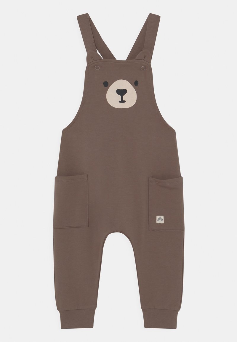 Salopette bébé marron avec visage d'ours sur la poitrine, bretelles réglables, deux poches avant et bas de jambes retroussés.