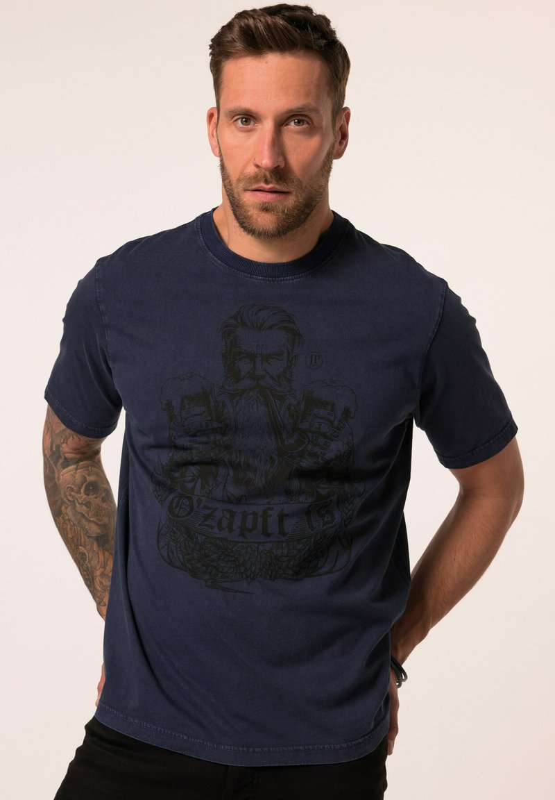 T-shirt in cotone blu navy a maniche corte, con una grafica di un uomo con barba e il testo "O'zapft Is" in nero. Tessuto liscio e vestibilità regolare.