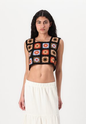 Black cropped top featuring a pattern of colorful squares with floral motifs in orange, blue, and tan against a textured background.