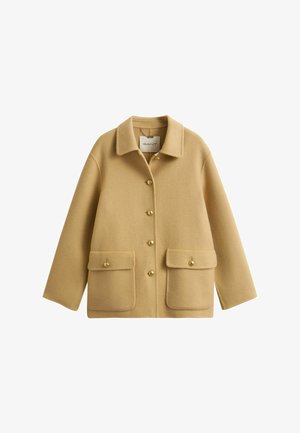 Beige Wolljacke mit Kragen, fünf goldenen Knöpfen vorne und zwei großen Klappentaschen mit Knopfverschluss auf Taillenhöhe.