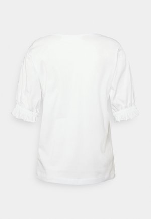 Chemise blanche à manches courtes avec poignets élastiqués froncés et ourlet droit, vue de dos sur un fond clair.