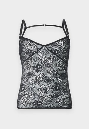 Schwarzes Spitzen-Camisole mit verstellbaren Trägern, das floral gemusterte und eine gewellte Borte entlang des Ausschnitts hat. Weiche, durchsichtige Textur.
