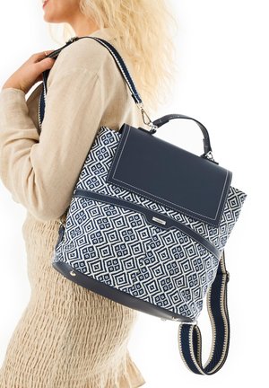 Navy and white patterned backpack with a textured, diamond design, featuring a top handle, adjustable strap, and metallic hardware accents.