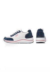 White and navy athletic shoes with suede and smooth leather; featuring red accent stripes, lace-up front, and a textured, cushioned sole.